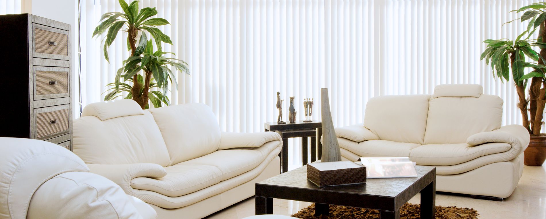 View at a bright living room with vertical window blinds