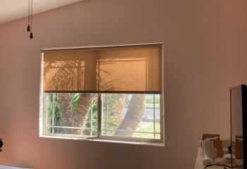 Saratoga guest bedroom window fitted with custom roller sheer shades, softly diffusing light for a cozy and welcoming atmosphere.