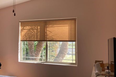 Close-up of bedroom window with elegant pull down window shades, showcasing premium sheer fabric and smooth operation.