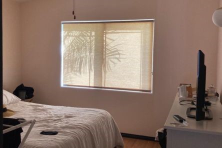Guest bedroom in Saratoga featuring high quality window shades on a large window, creating a stylish and comfortable private retreat.